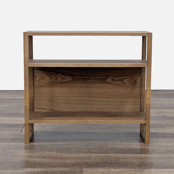 Front view of an Inside Weather wooden bookshelf with a simple two-tier design and included anti-tip hardware.