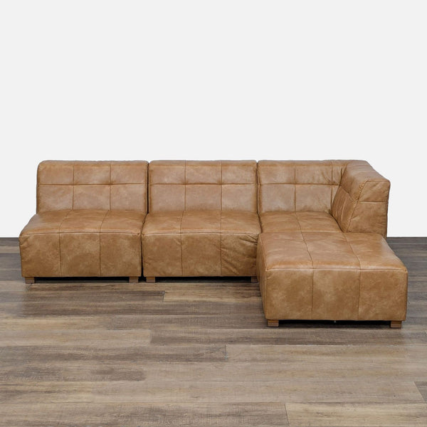 L-shaped sectional in faux leather with square tufting.  