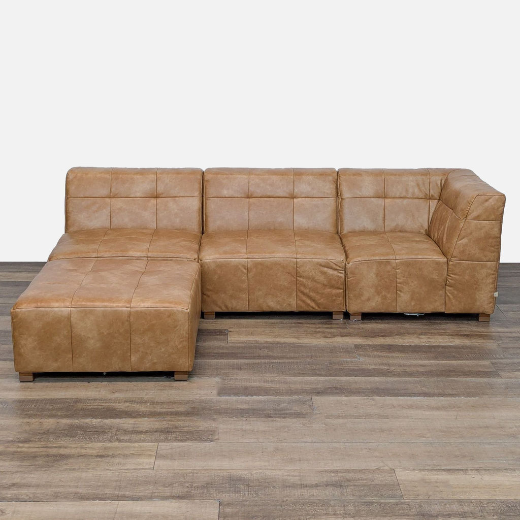 Faux leather sectional couch, L-shaped with tufted design.