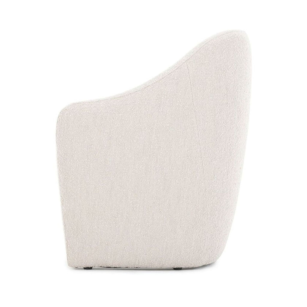 Side profile of a stylish dining chair by Four Hands, featuring high-performance, wear-resistant fabric.