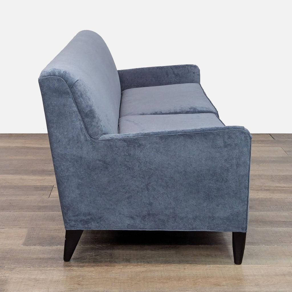 Side view of a velvet-upholstered 3-seat couch, showcasing Danish modern design and wooden tapered legs.