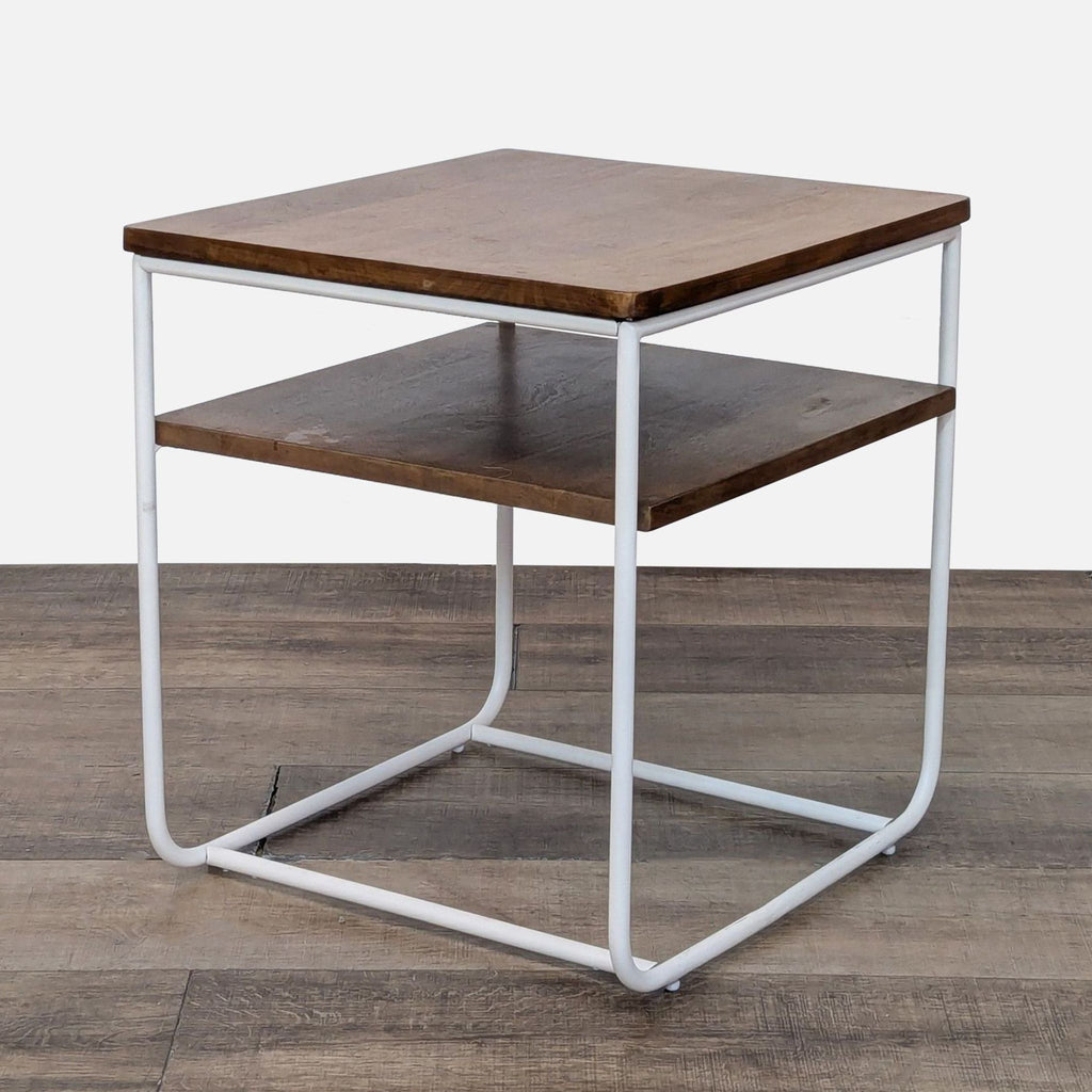 Modern end table featuring mango wood shelves and a sleek white metal base.