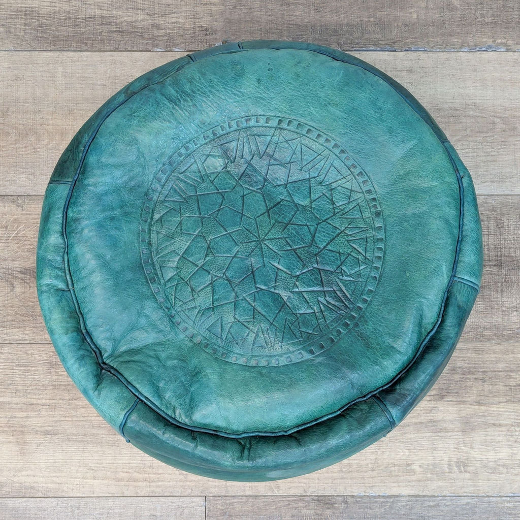 Top view of a green Reperch ottoman with embossed pattern.