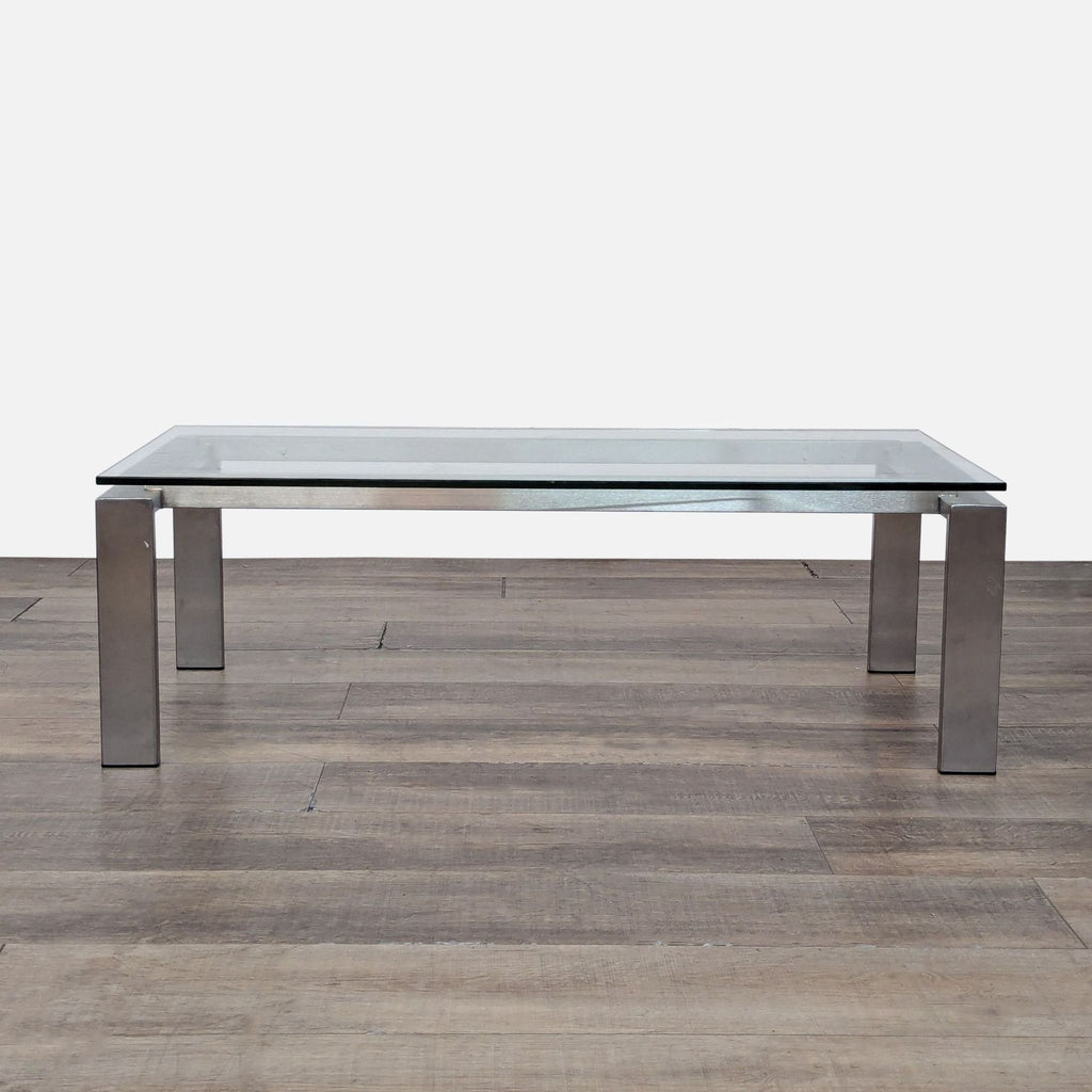 Room & Board coffee table with a sleek glass top and metal base.