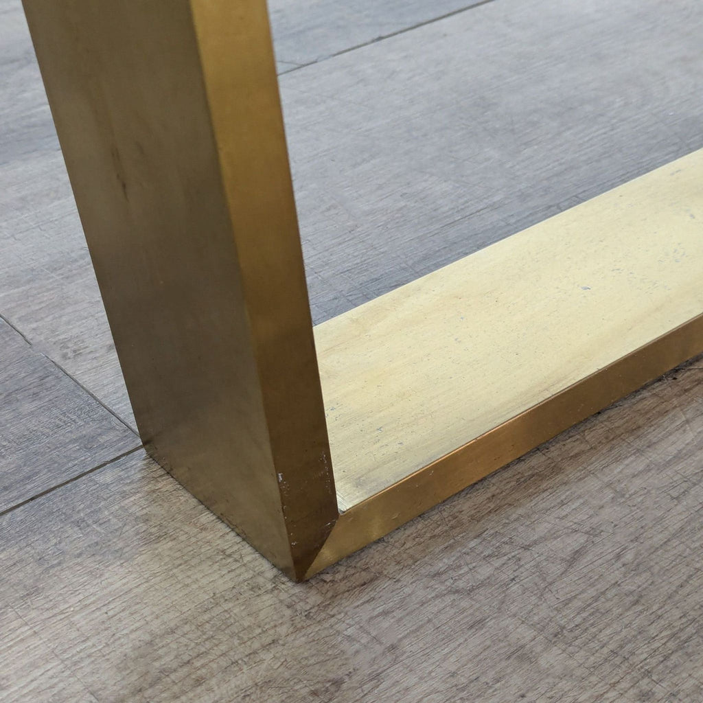Detail of brushed gold finish on steel sled legs.