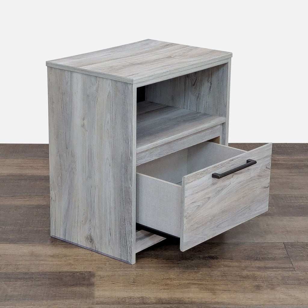 Engineered wood nightstand featuring one drawer, open shelf, and USB charging station.  