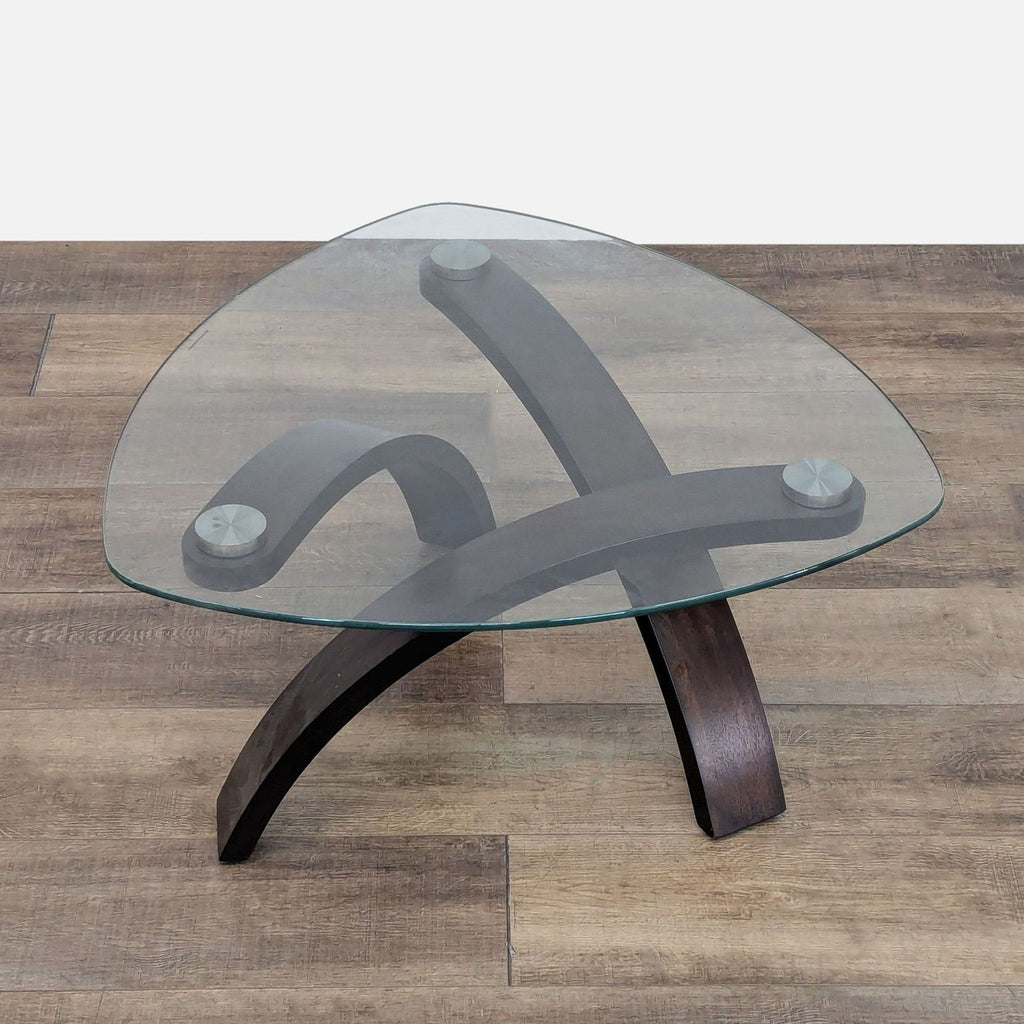 Reperch coffee table featuring a tempered glass top and wood base.