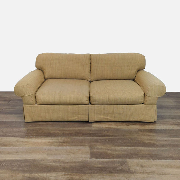 Tan loveseat with rolled arms and plush cushions by Lee Industries.