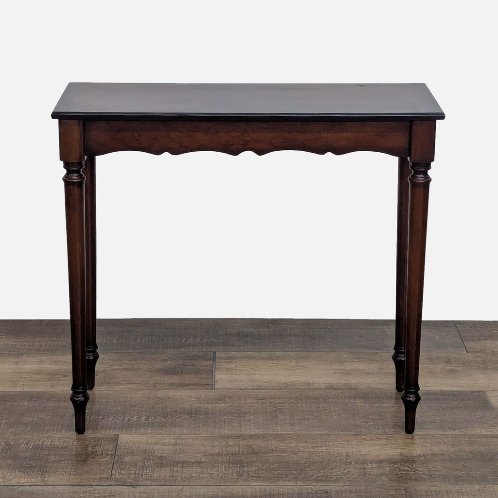 Elegant side table with dark cherry finish and carved legs.