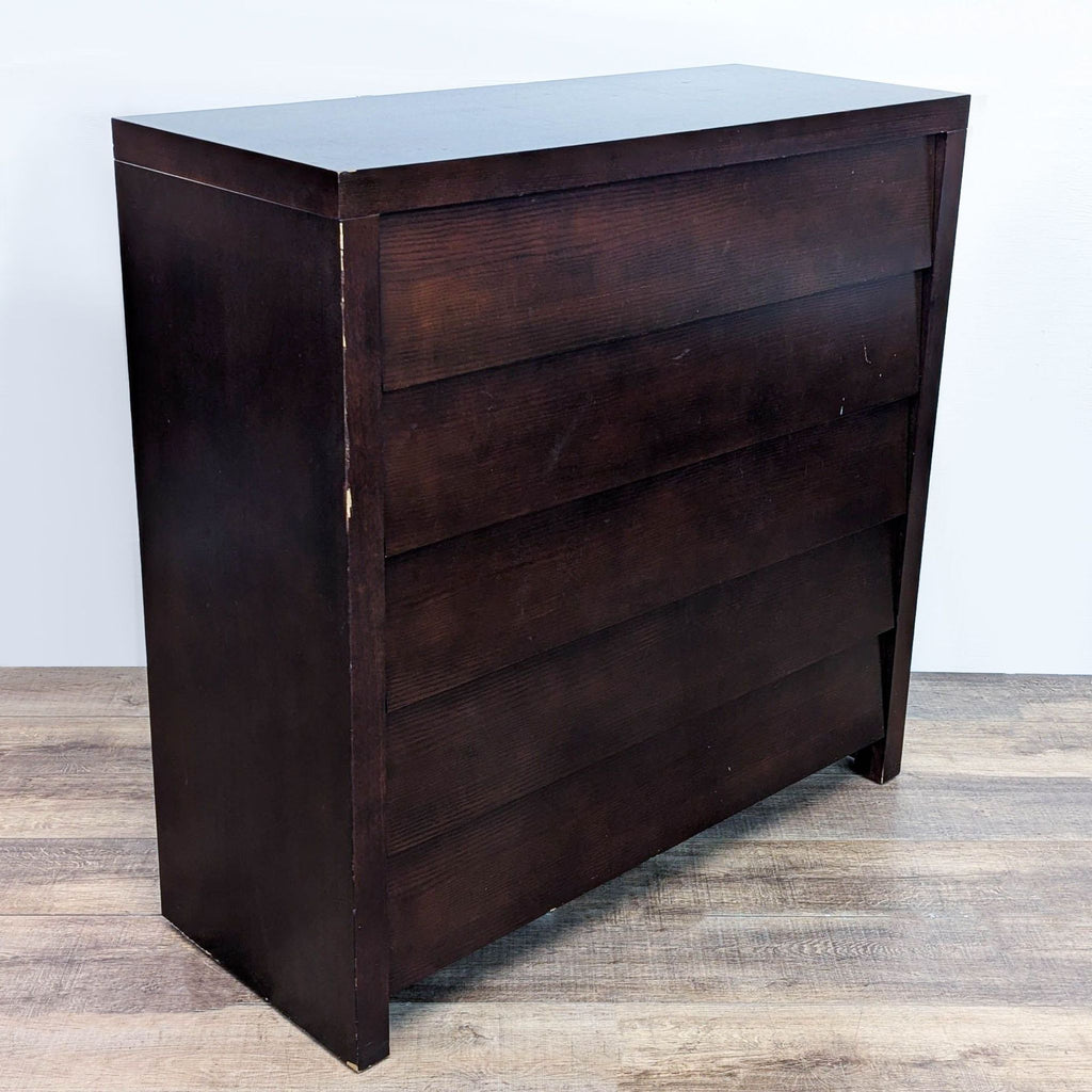 Side view of dark-finished 5-drawer dresser.