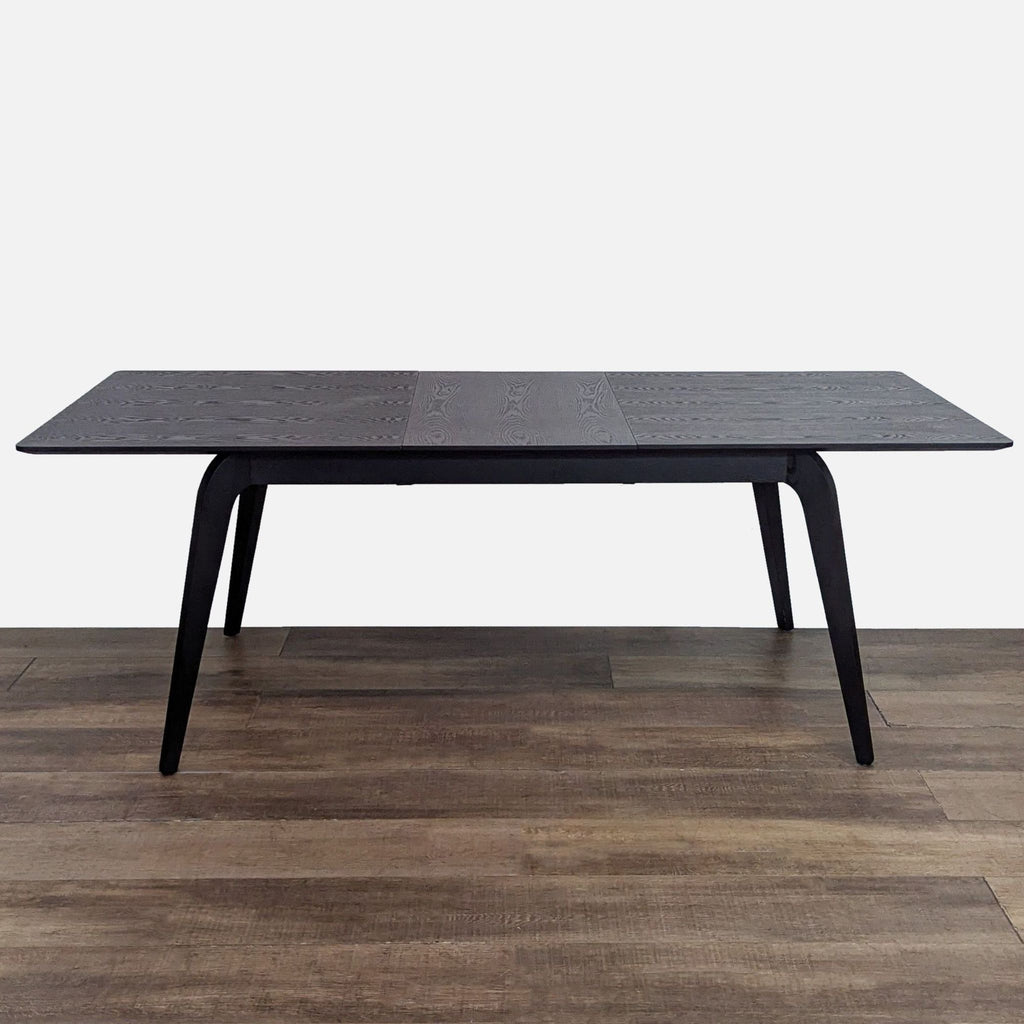 Walnut finish dining table from All Modern with expandable leaf.