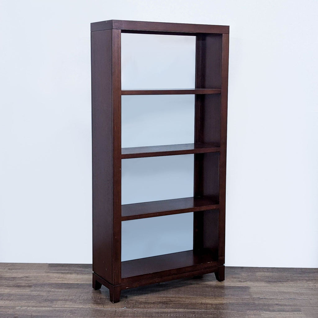 Modern oak bookshelf featuring four fixed dark shelves.