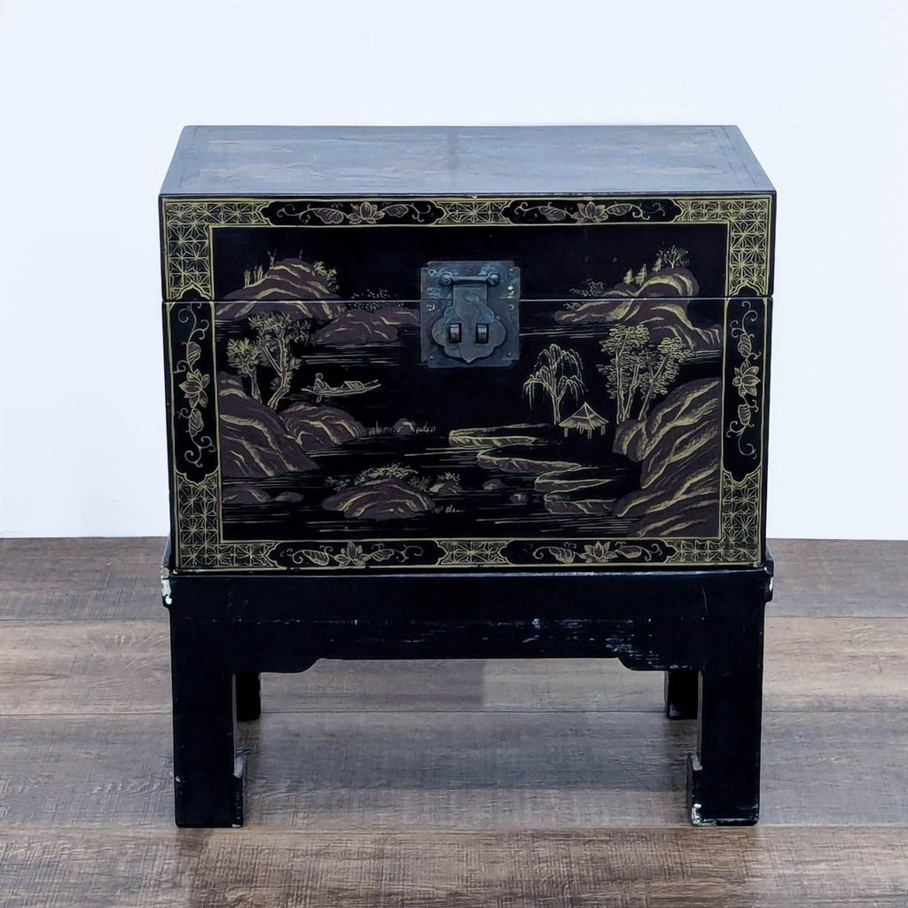 Elegant lacquered trunk with metal lock, displaying artistic hand-painted landscapes on a stand.