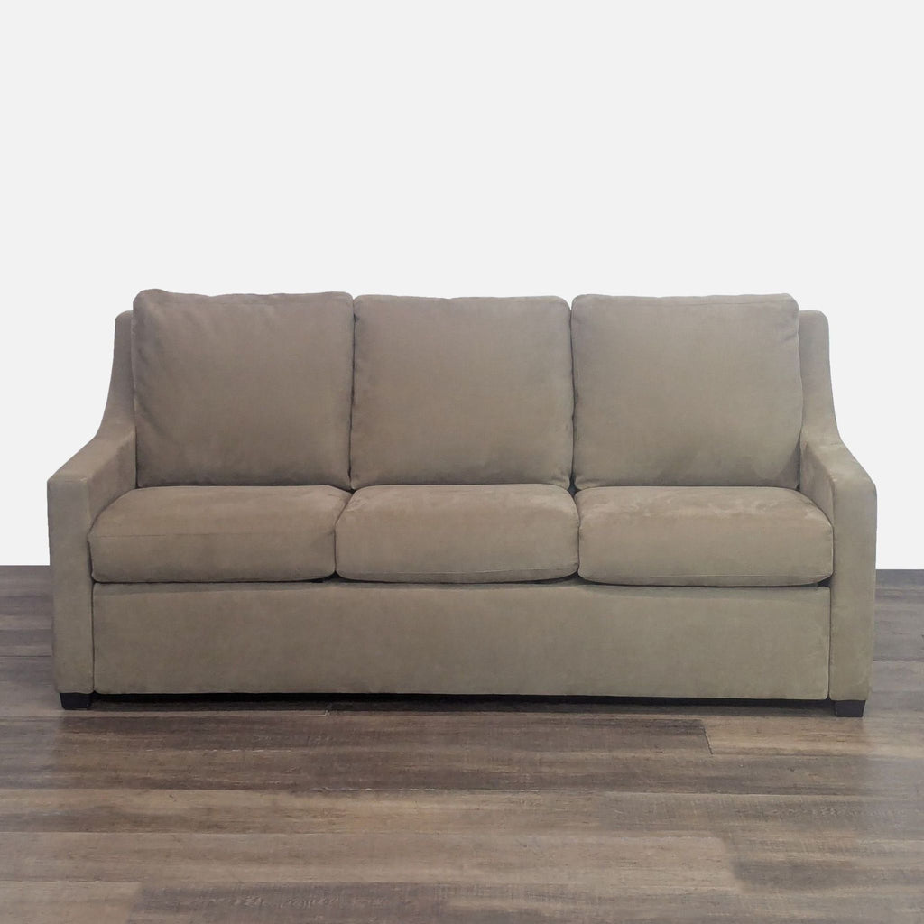 Contemporary sleeper sofa with sloped arms and plush cushions, Crate and Barrel.
