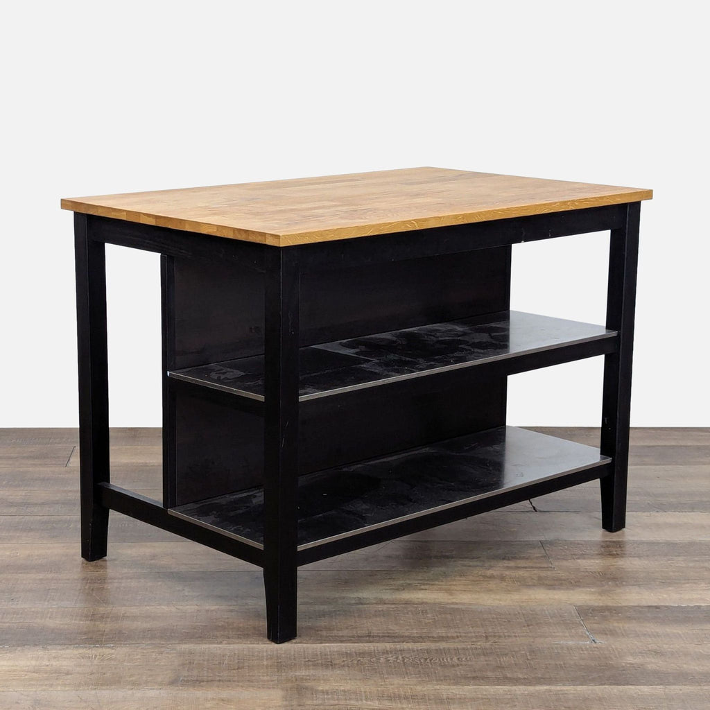 Butcher block top table with black steel frame and two shelves on one side.
