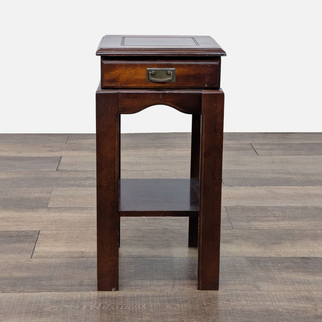 Traditional dark wood side table with drawer and lower shelf.