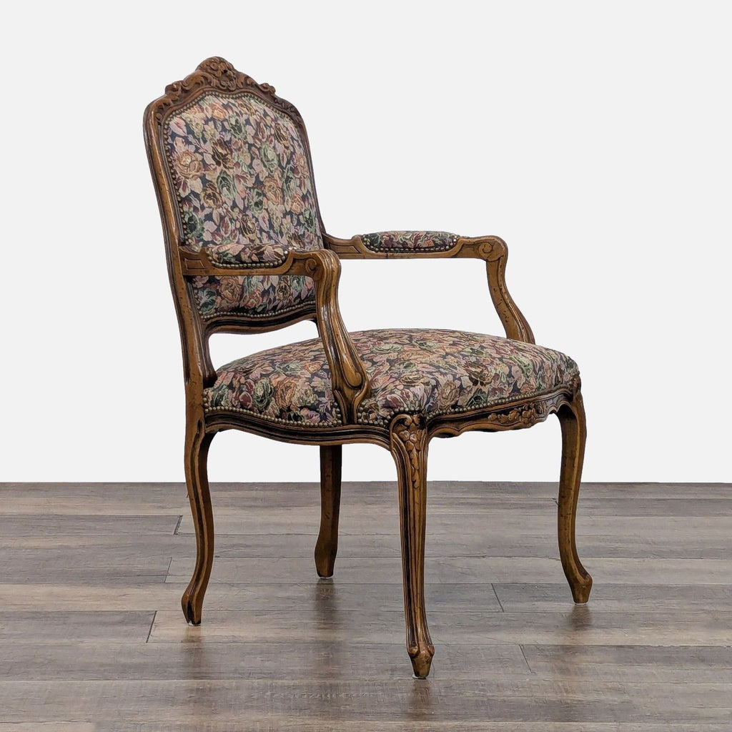 Chateau D'Ax chair with detailed wooden carvings and luxurious floral upholstery.