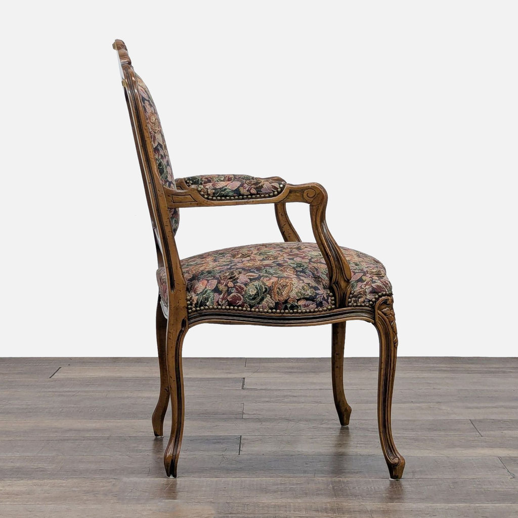 Elegant lounge chair featuring intricate carvings and plush floral fabric.