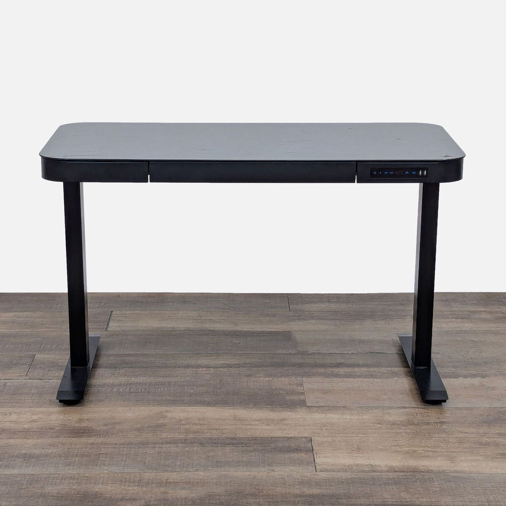 Stylish black desk with tempered glass top and touchscreen controller.