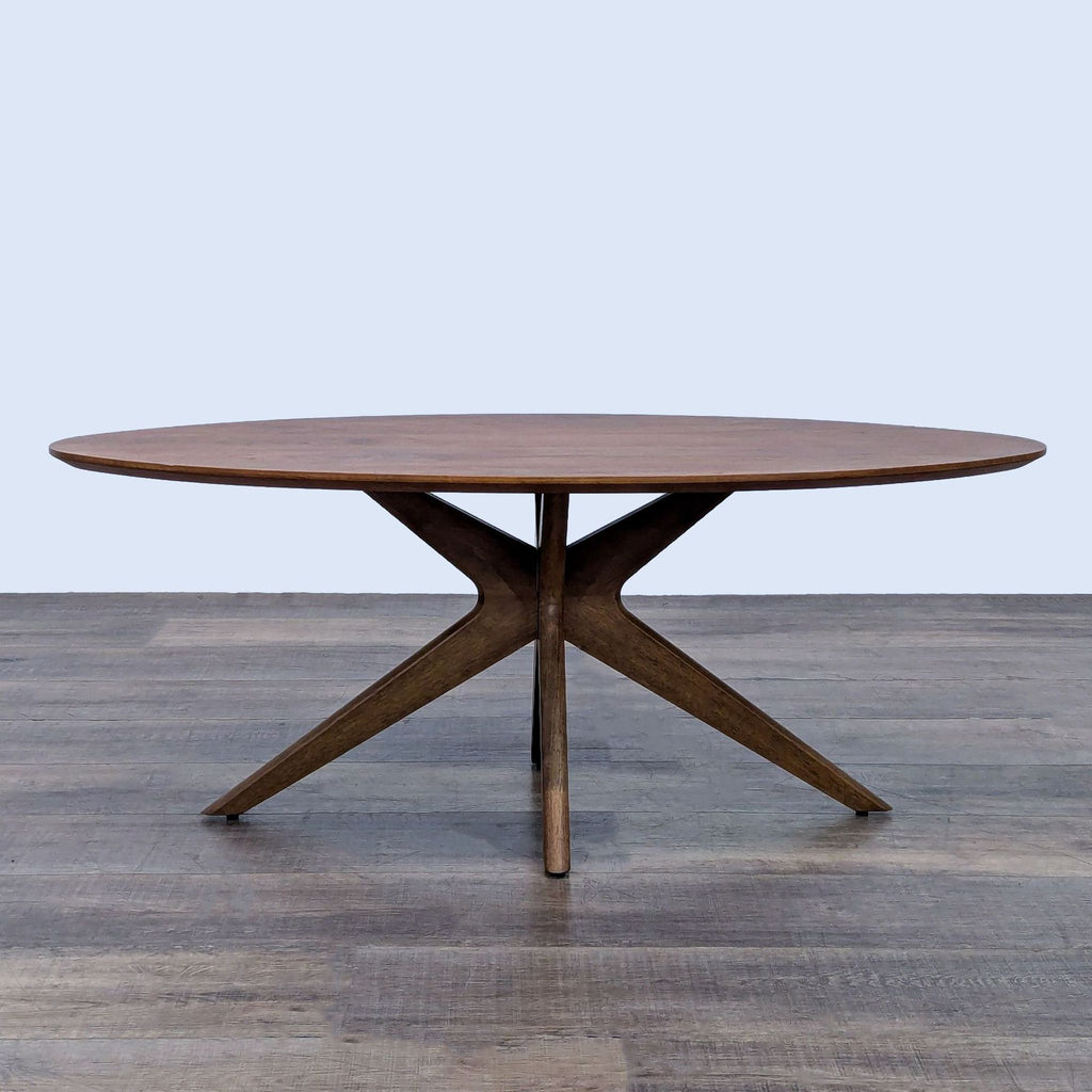 Round walnut coffee table with a modern base made of rubberwood.