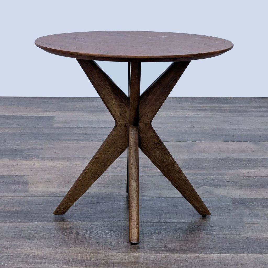 Round end table with rubberwood and walnut veneer in a walnut finish on a wooden floor.
