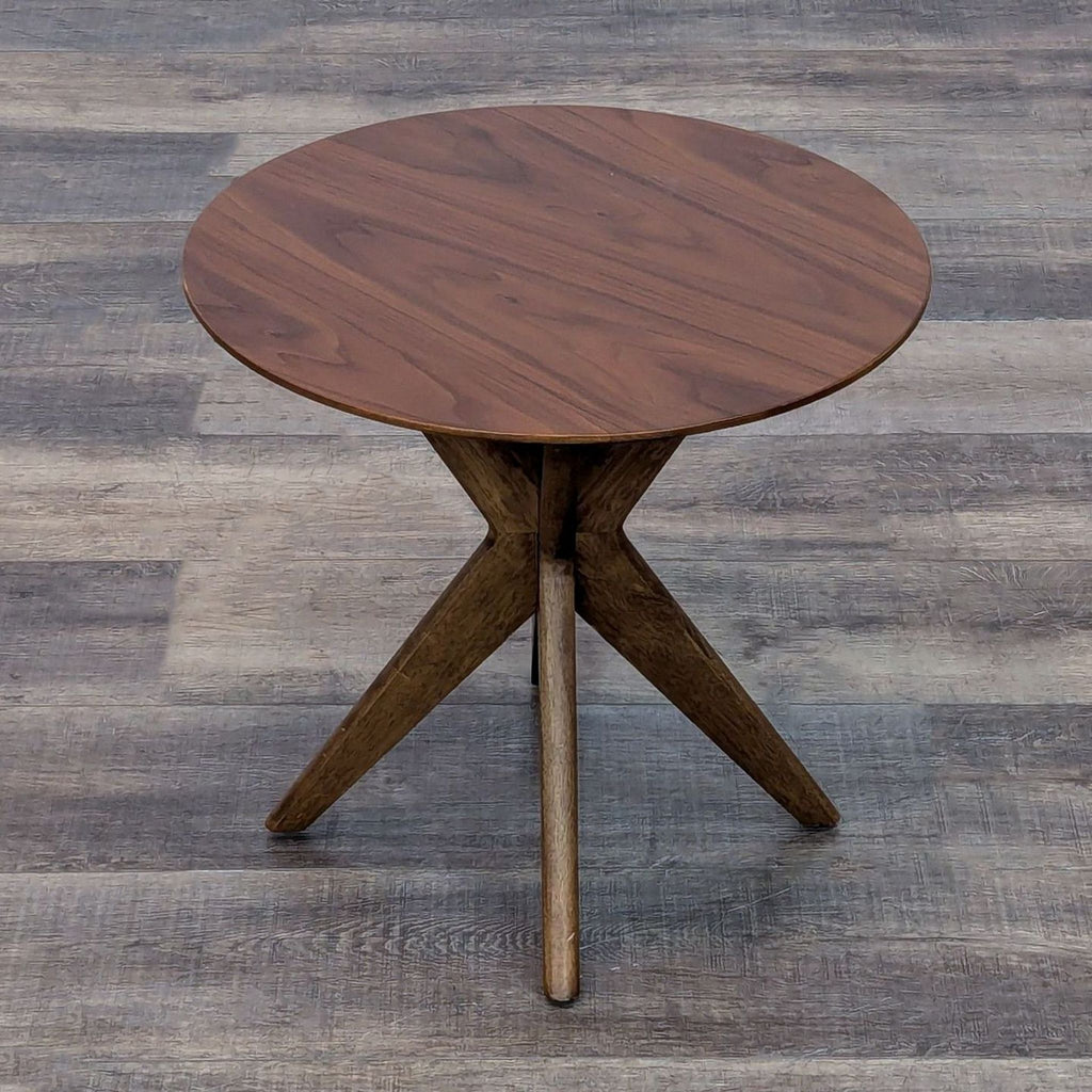 Castlery end table in walnut finish with round top and cross-legged base.