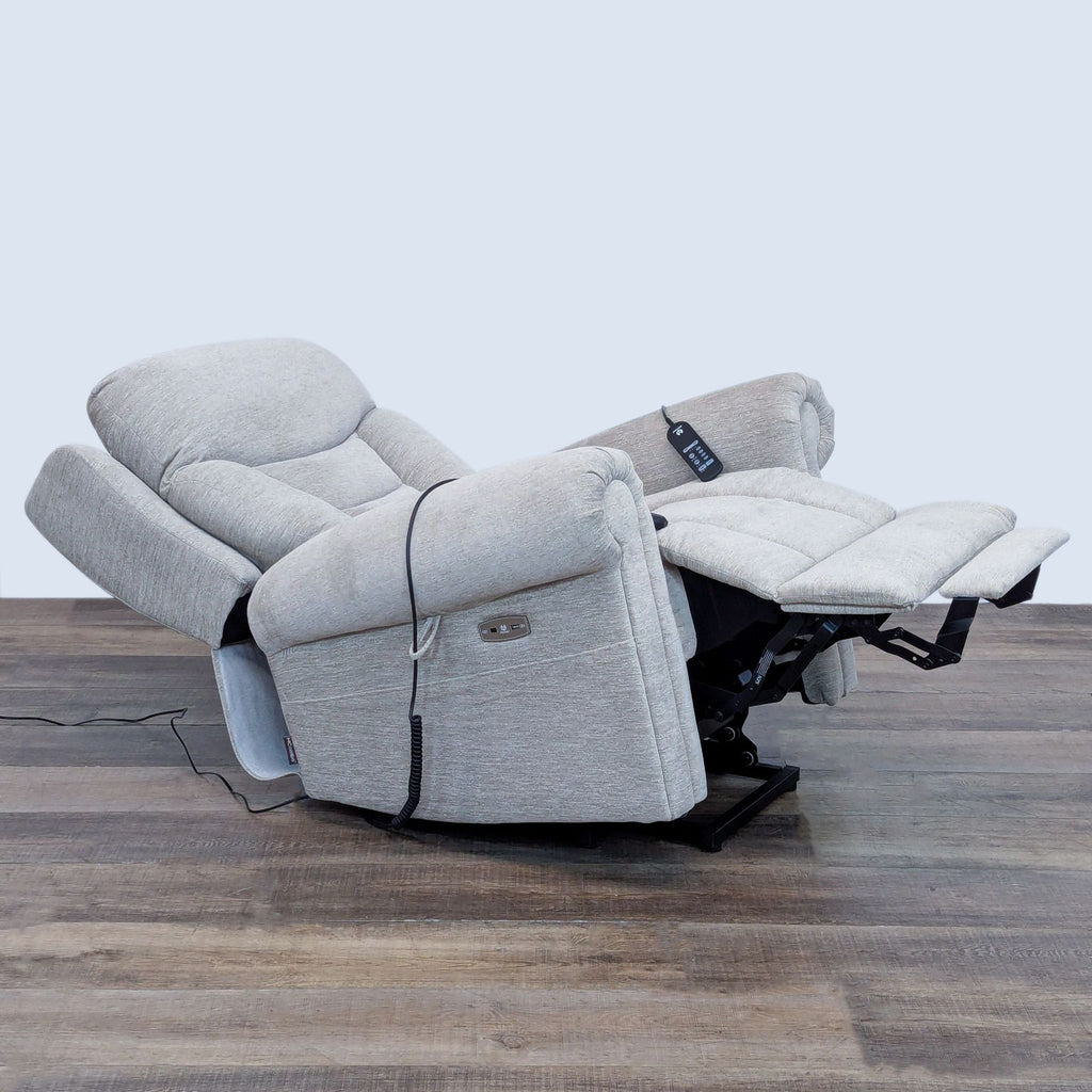 Side view of a reclined chair featuring an extended footrest and remote control.