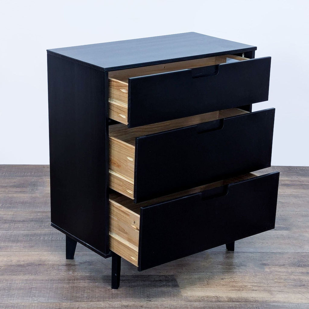 Black-stained dresser with three open drawers, showing a side angle.