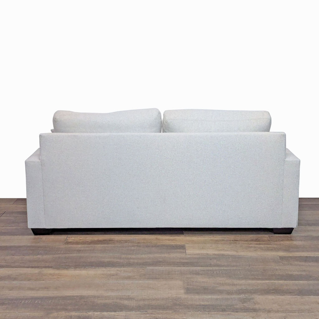 Rear view of Pottery Barn loveseat, highlighting a sleek, modern design.