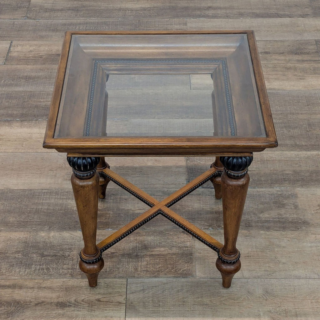 Square wood table featuring a recessed top with bead trim and decorative legs.