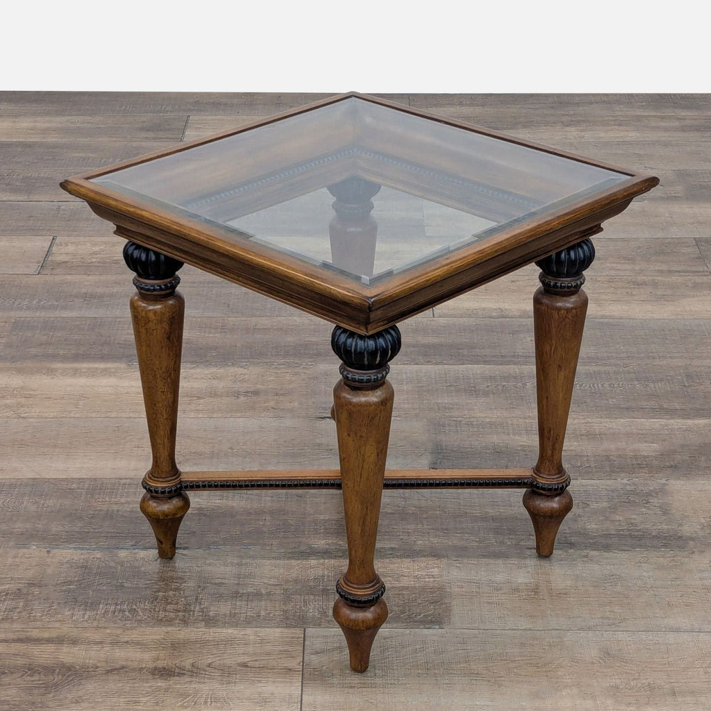 Wood end table with carved frame and bead trim on top, legs, and braces.