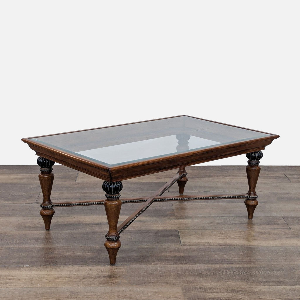Intricately designed coffee table with a recessed top, featuring a carved and beaded frame.
