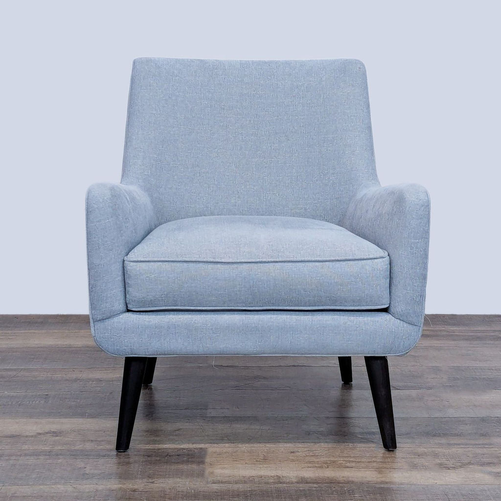 Mid-century style lounge chair with dark wood legs, front view.