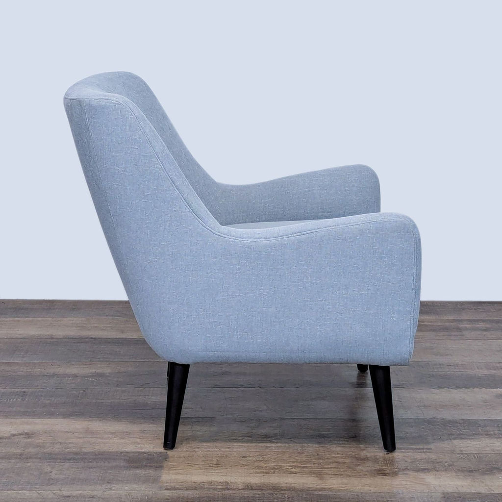Side view of Room and Board lounge chair with sleek, solid legs.