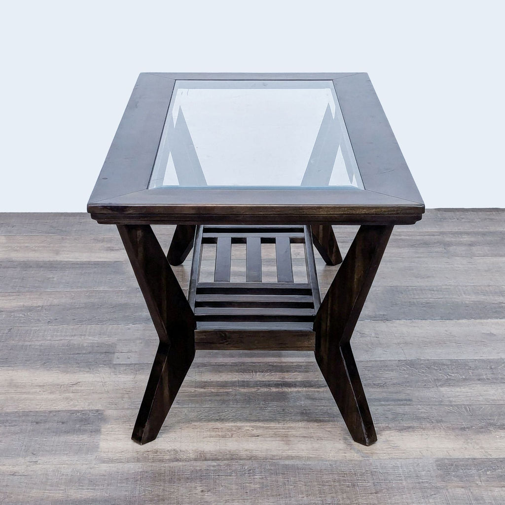 Modern Reperch coffee table with splayed legs, glass top, and slatted wood shelf beneath.