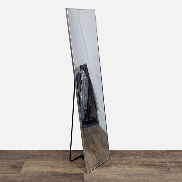 Full-length Reperch mirror with a sleek frame on a wooden floor.