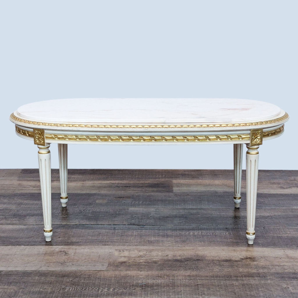 Oval marble-top table with foliate apron; fluted legs by Reperch.  