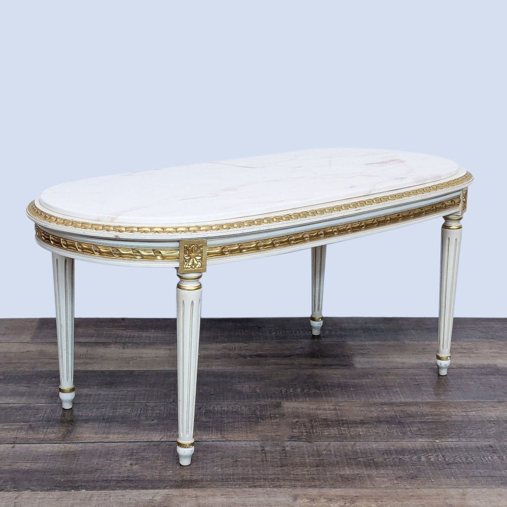 French style marble-top coffee table with detailed apron and tapering legs.  