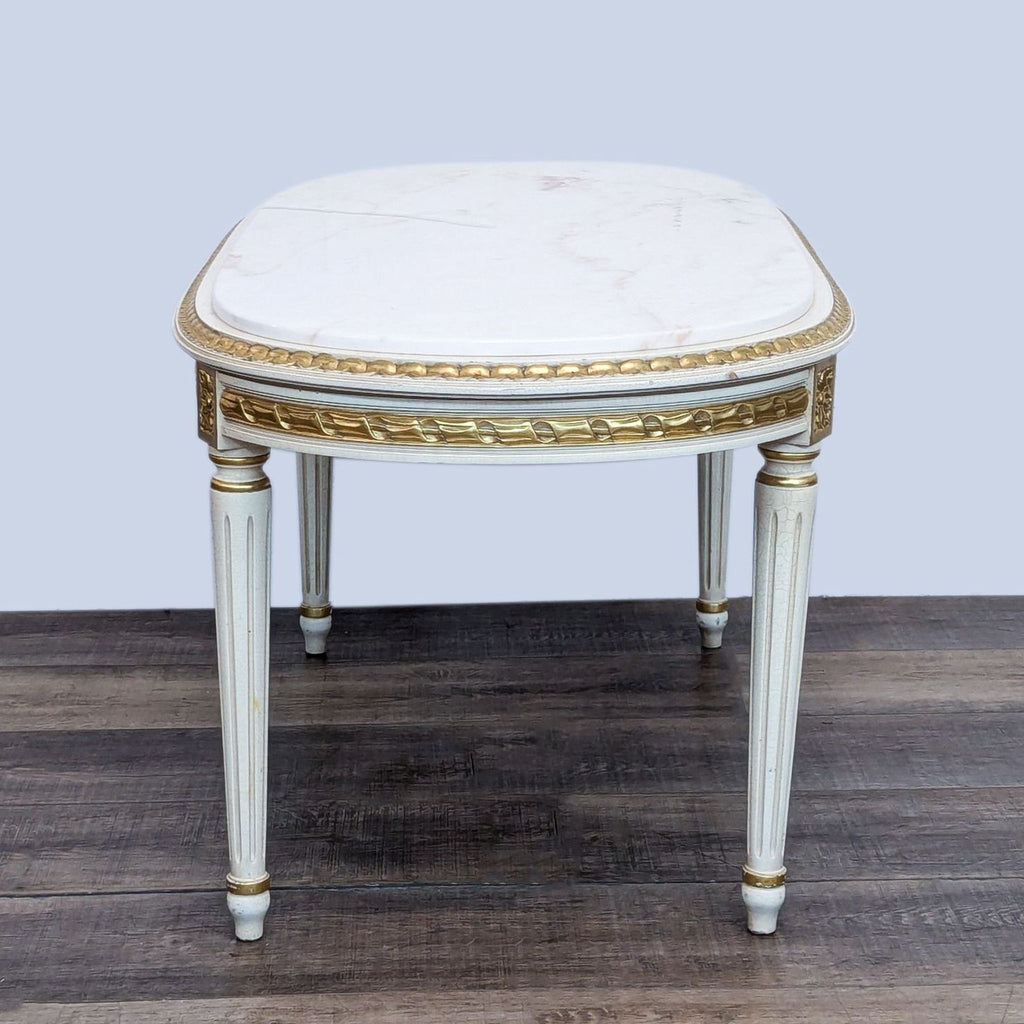Reperch coffee table with ornate foliate design and marble top.