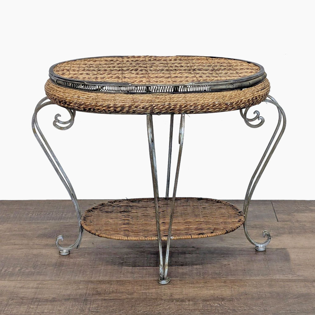 Round wicker and metal console table by Reperch with a lower shelf and decorative legs.