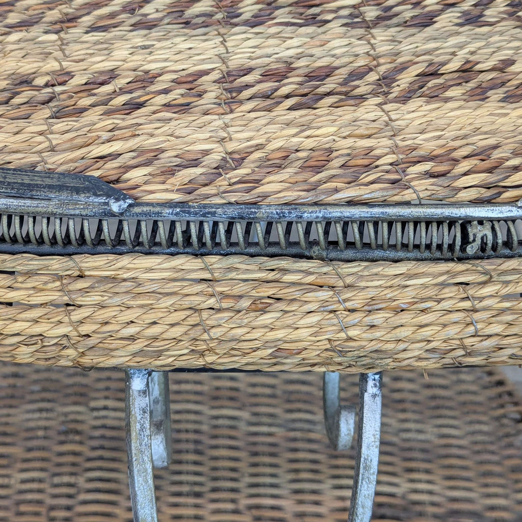 Close-up of the wicker texture on a Reperch side table, highlighting intricate weaving and metal edge.
