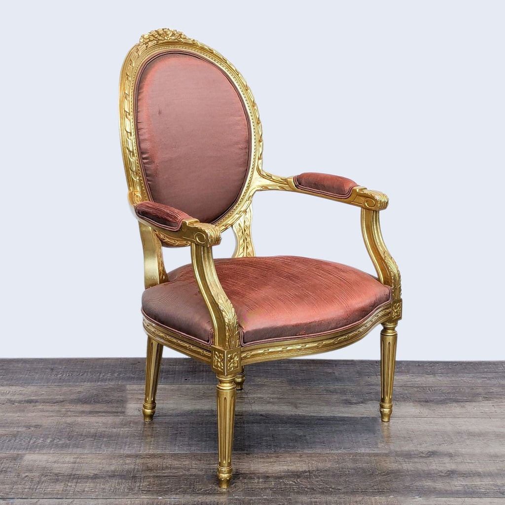 Angled view of a gold ornate armchair with an upholstered seat and back.