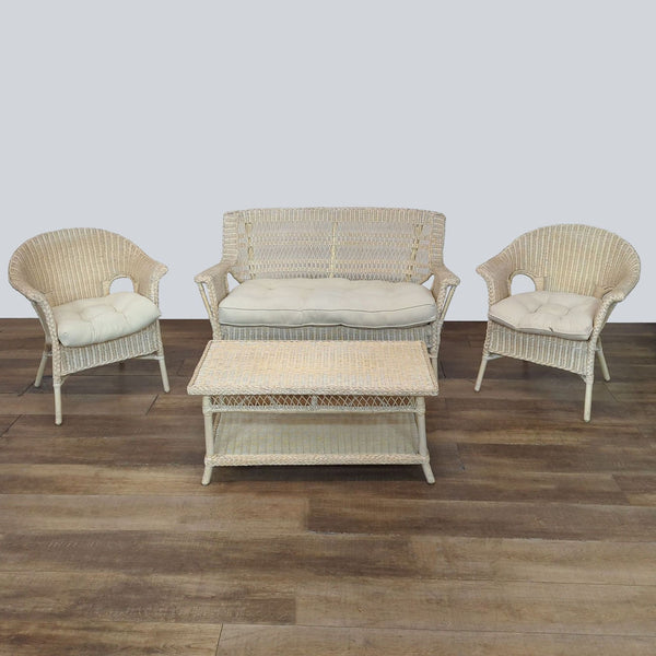 Woven wicker furniture set with matching sofa, chairs, and table, featuring tufted cushions.