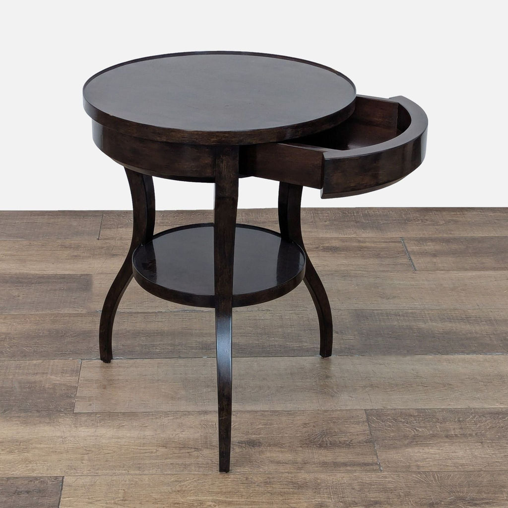 Side table with open drawer and unique leg design.
