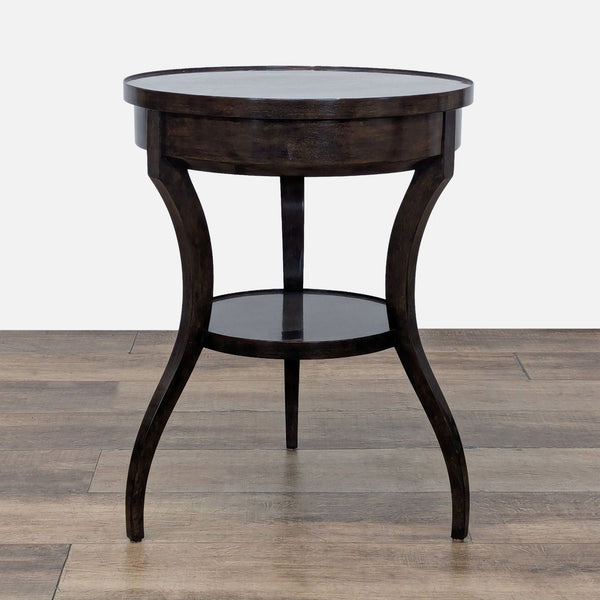 Round wood table with cabriole legs and shelf.