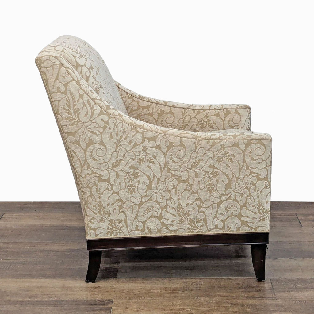 Side view of lounge chair featuring floral upholstery and dark wooden legs from Kravet Furniture.