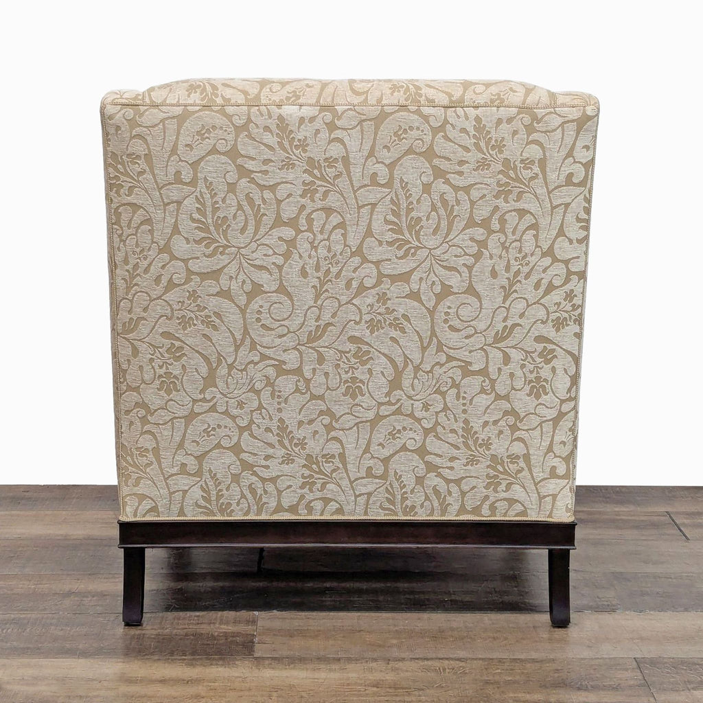 Back view of Kravet Furniture chair with intricate floral upholstery and dark wood accents.