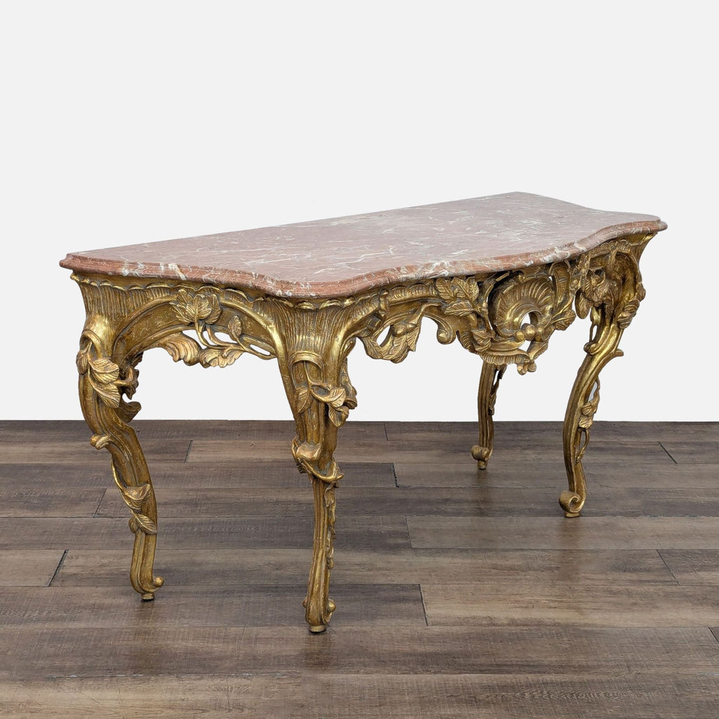 Elegant side table with intricate gilded design and marble surface.