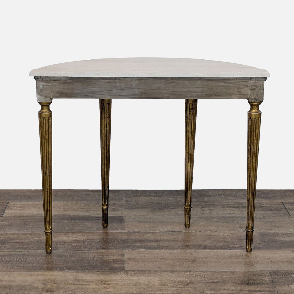 Elegant side table with ornate gold legs and a carved floral motif from Reperch collection.
