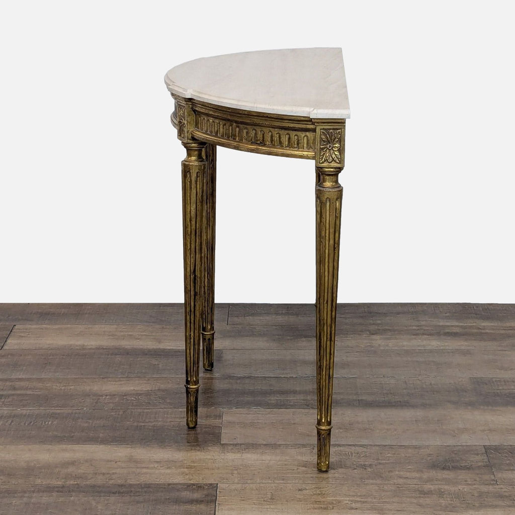 Console table featuring floral carvings and fluted, gilded pin legs by Reperch.